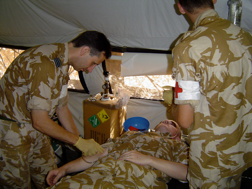 Medics tend to patient with drip tube.
